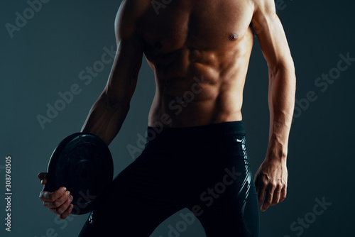 muscular man exercising with dumbbells