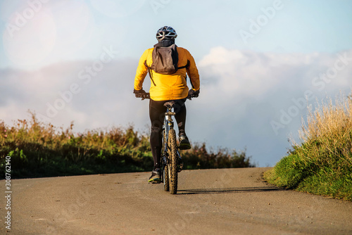 man doing mountain bike at sunset