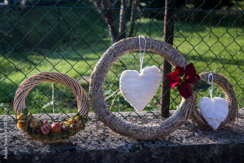 White decorative heart hanging on a circle of straw