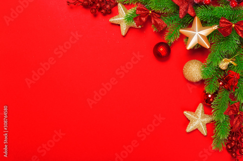 Christmas red background with herringbone and decor. Gold and red jewelry. Top view with space for copy.