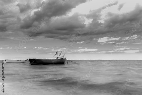 Small boat at the sea (black and white)
