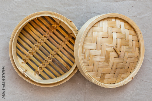 Quadro su tela Bamboo steamer set, chinese kitchenware on grey paper, top view