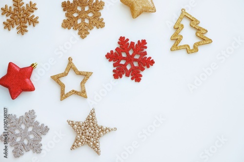 Christmas and New Year composition. Christmas decorations of gold, silver and red on a white background. Top view, copy space for text.