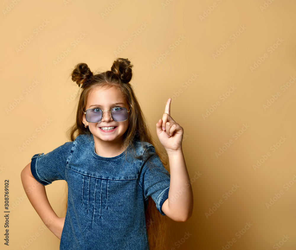 Cute girl in jeans sundress and sunglasses posing on camera. Cute girl in jeans sundress and sunglasses posing on camera.