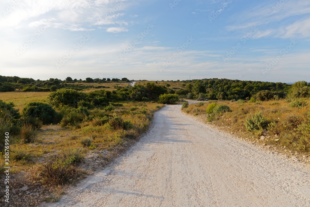 Dirt road leading forward on mediterranean lands Dirt road leading forward on mediterranean lands