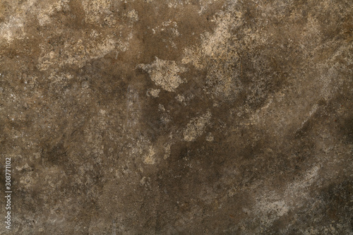Brown cement wall with smudges and scratches as well as signs of aging