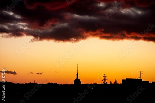 Silhouette of Ostrava-Poruba city hall  Porubska radnice  during beuatiful sunset with dark clouds