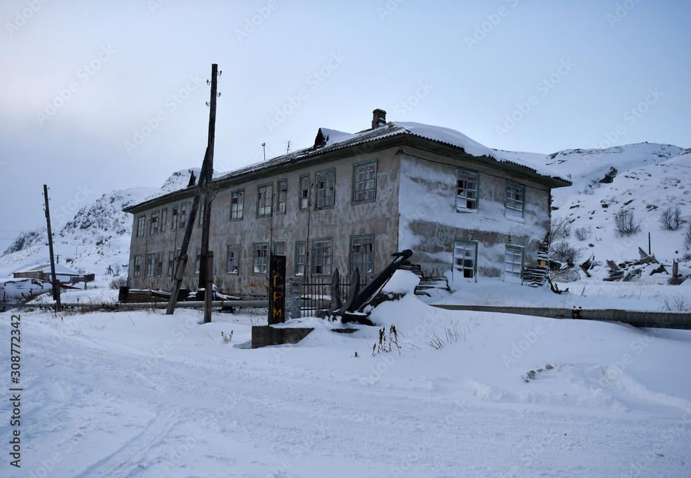 old houses under snow in the Russian Arctic
