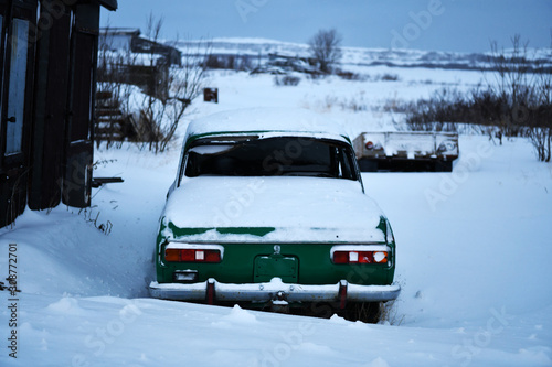 old cars under the snow in the Russian Arctic