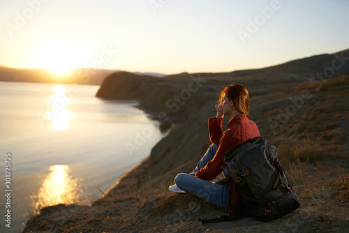 woman sitting on top of mountain