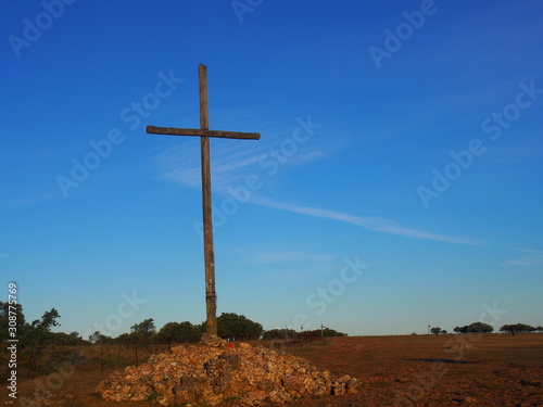 Iron cross with blue sky on the road to Santiago de Compostela, Camino de Santiago, Way of St. James, Journey from Atapuerca to Burgos, French way, Spain