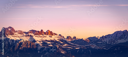 Snowy rocky mountain with a beautiful pink sunset, space fort text