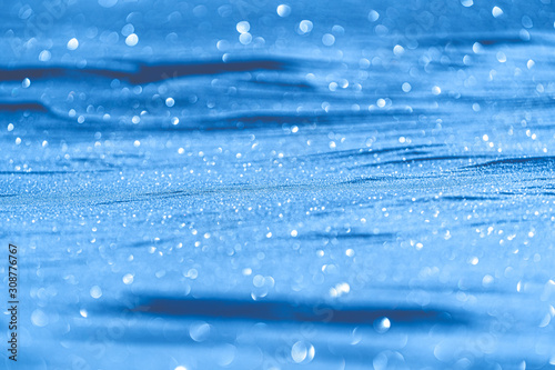 Christmas background of blue snow with bokeh effect, perfect for writing