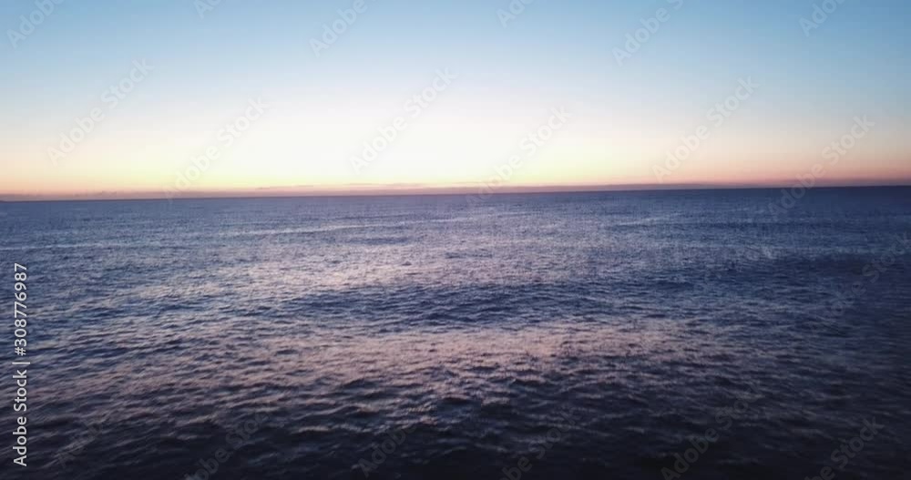 Tilt Up Cinematic Aerial of Ocean Water in Twilight Before Sunset With Light Reflection Tilt Up Cinematic Aerial of Ocean Water in Twilight Before Sunset With Light Reflection