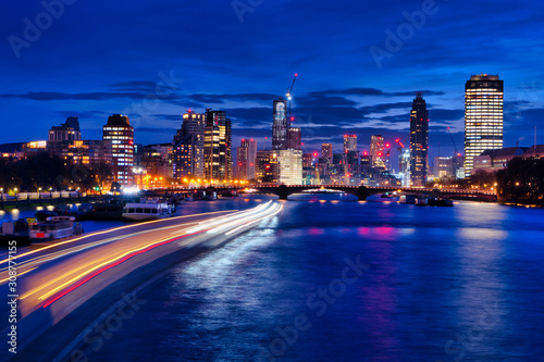 Night view of the modern part of London, river in the low sky beautiful