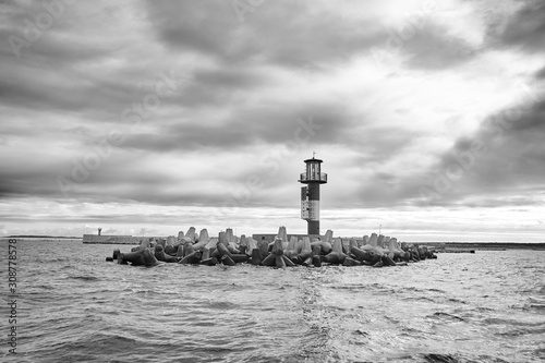 Black and white picture of a sea beacon with stormy clouds.