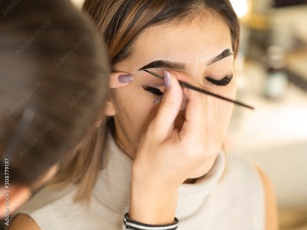Eyebrow tinting. Close up master applying brow tint with a brush. Cosmetic  procedures, eyebrow permanent makeup Stock Photo | Adobe Stock