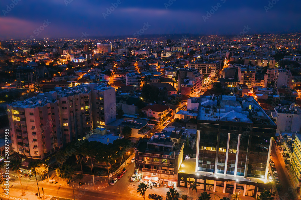 Obraz Aerial view of Limassol cityscape, first coastline buildings in Cyprus at night. Drone photo of mediterranean sea resort Limassol from above.