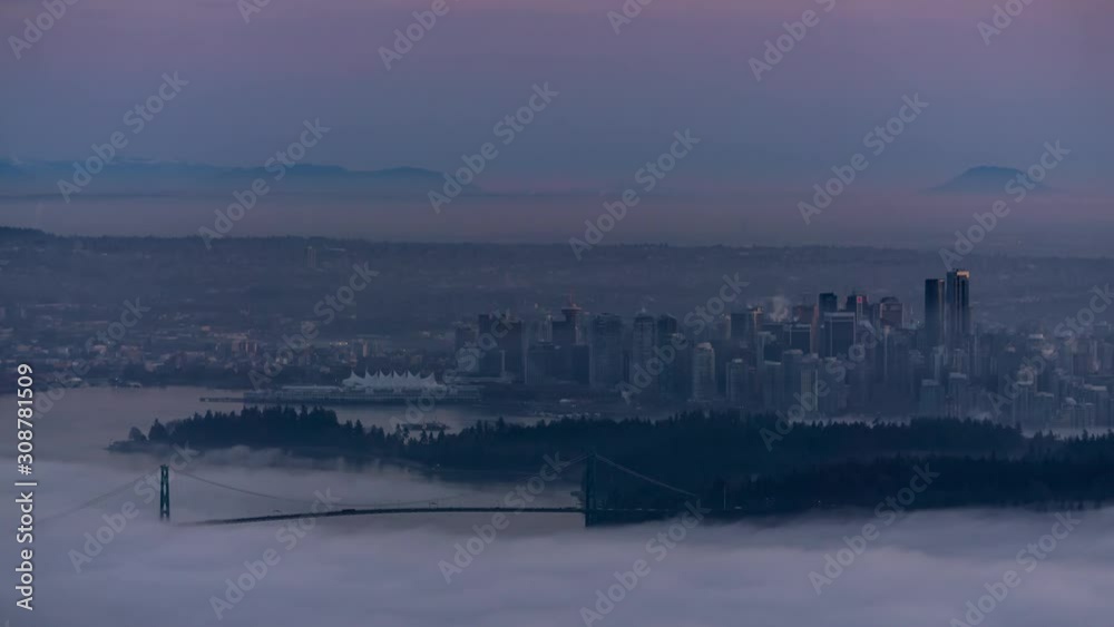Time Lapse of Downtown Vancouver City Buildings and Stanley Park View. Picture taken during a cloudy evening from Cypress Mountain Viewpoint, West Vancouver, British Columbia, Canada. Time Lapse of Downtown Vancouver City Buildings and Stanley Park View. Picture taken during a cloudy evening from Cypress Mountain Viewpoint, West Vancouver, British Columbia, Canada.