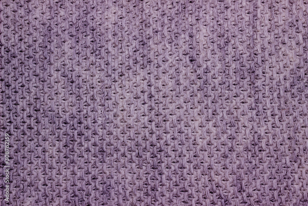Knitted woolen background. The texture of light blue wool close-up. Knitted fabric, handmade, machine knitting.