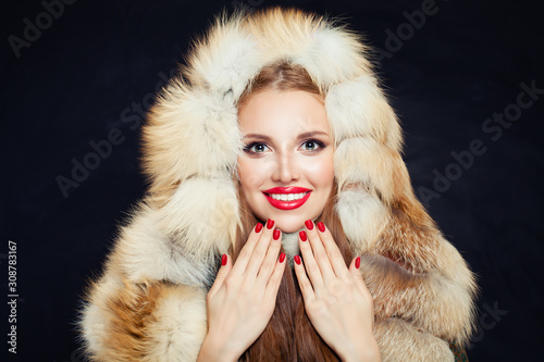 Wallpaper Mural Beautiful winter woman with red nails in fur hood isolated on black background