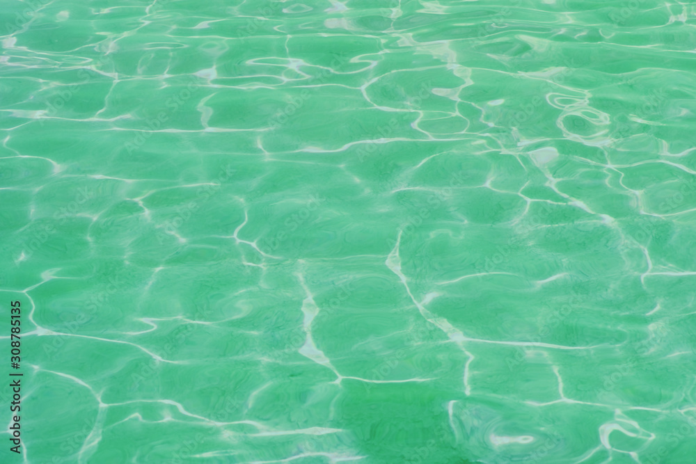 surface of green swimming pool. Background water in sea.