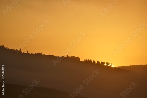 Orange sunrise behind Pienza