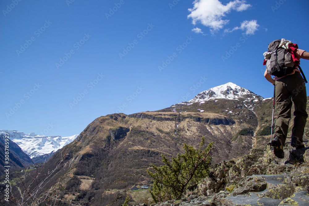mountain hiker in the spring with the snowy Gavarnie cirque at the back