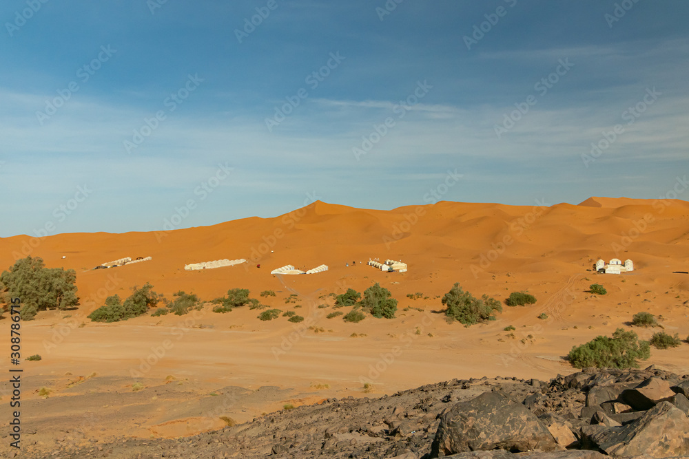 Typical desert landscape in the Atlas of the Sahara desert in Morocco with tourist jaimas