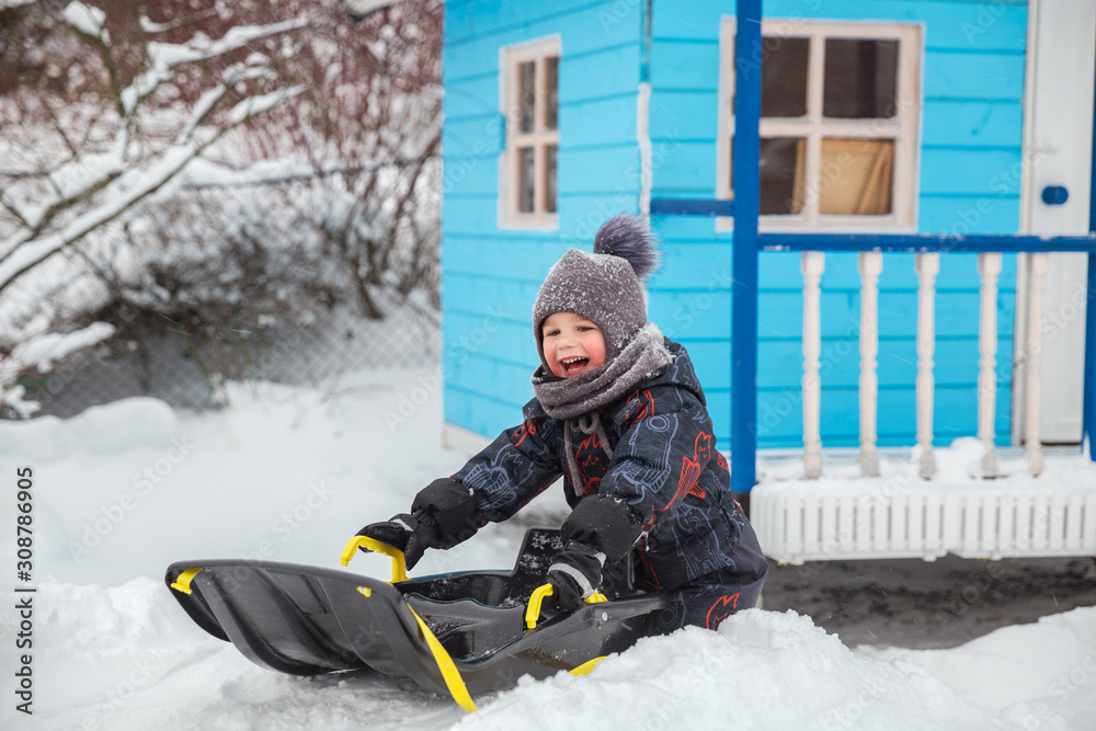 Little boy sledding in winter Little boy sledding in winter