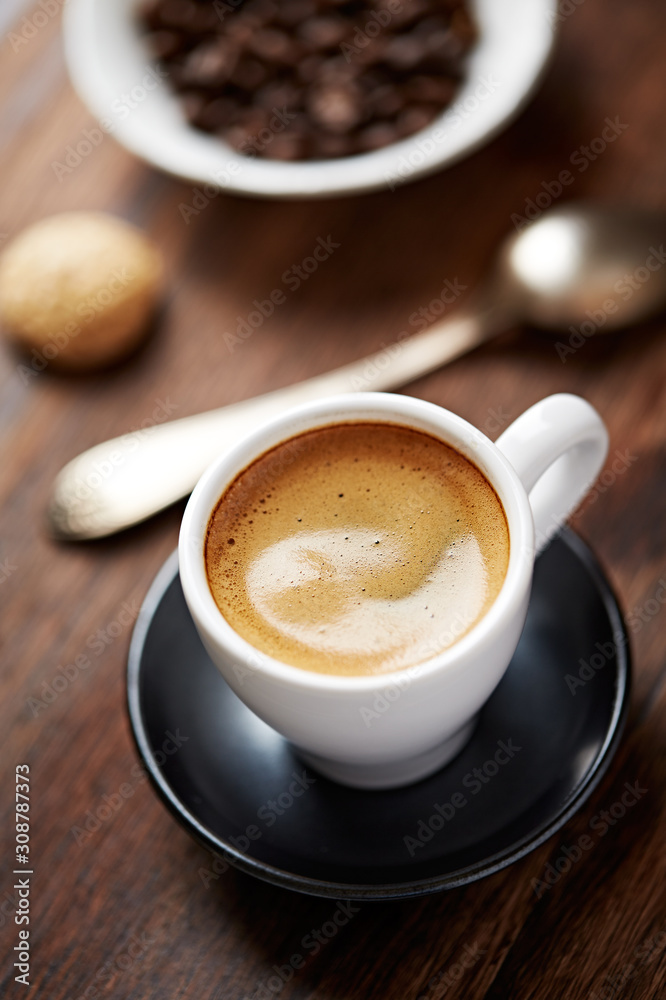 Cup of coffee with amaretti (Italian biscuit) on rustic wooden background. Close up. Cup of coffee with amaretti (Italian biscuit) on rustic wooden background. Close up.