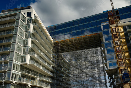 Photography Construction scaffolding for SkyBridge cladding at Pier 27 Condominiums at lake