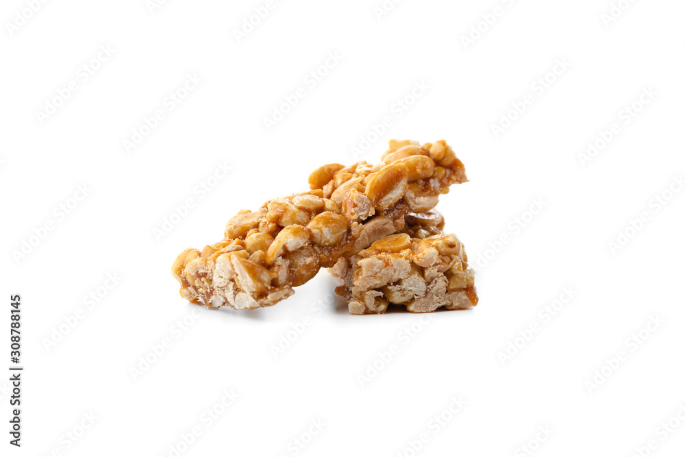 Kozinaki on a white background. Peanuts in caramel close-up. Eastern sweetness.