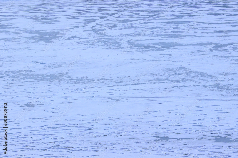 Blurry human's silhouettes on frozen lake. Cropped shot of frozen lake. Abstract winter background. Winter landscape. Blurry human's silhouettes on frozen lake. Cropped shot of frozen lake. Abstract winter background. Winter landscape.