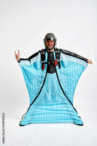 Two fingers. Men in wing suit show two fingers. Skydiving men in parashute. Simulator of free fall.