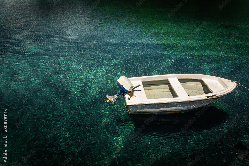 Boat in calm lake water.