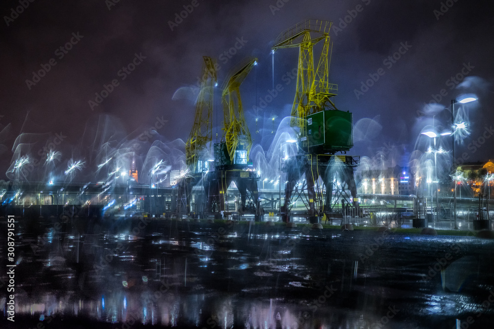 Dźwigozaury - Cranesaurs - colorfully illuminated cranes on the quay of Szczecin Łasztownia	