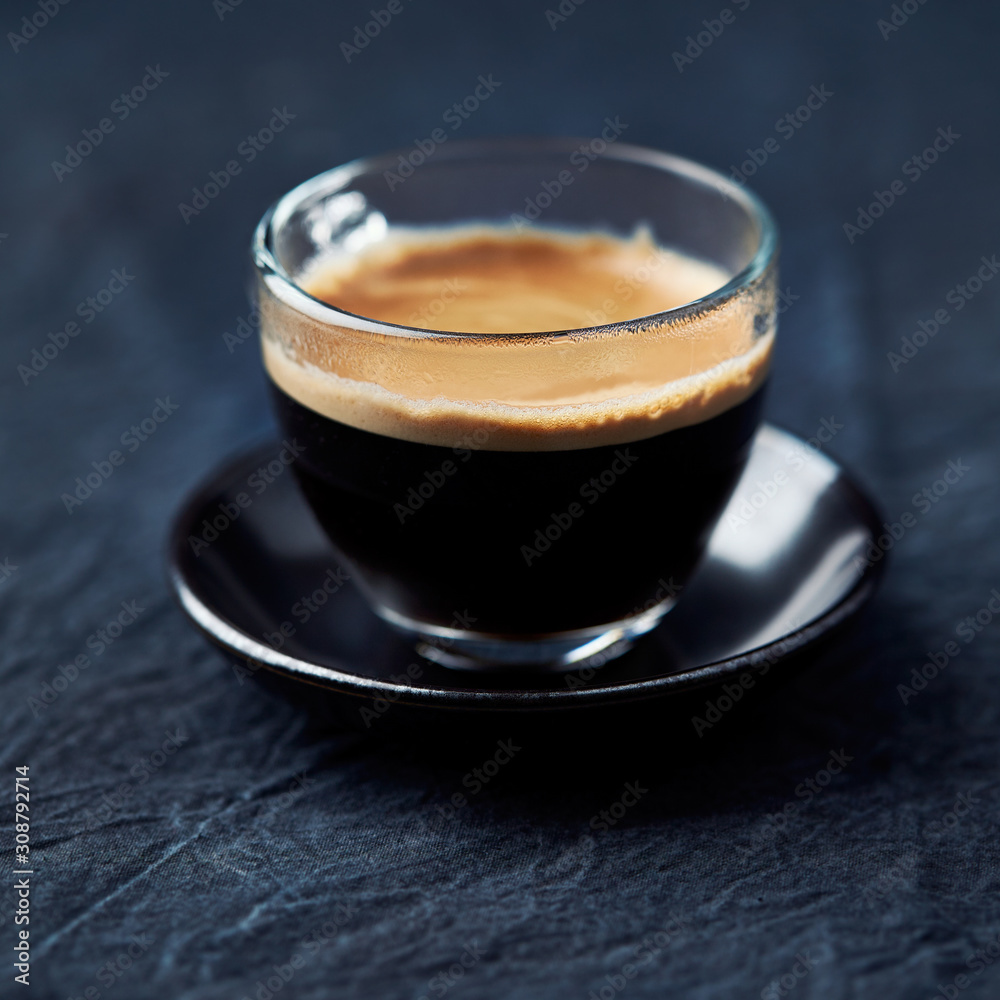 Coffee in glass cup on dark background. Close up. Coffee in glass cup on dark background. Close up.