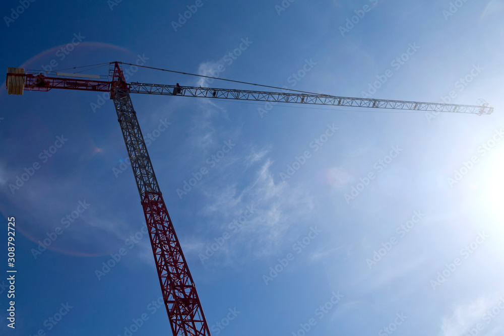 Tower crane in front of shiny sky