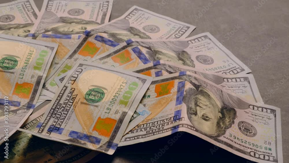 USD 100 dollars too much standing on a black background,
