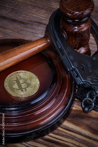 bitcoin, judge's hammer, handcuffs. Concept bitcoin ban, violation of the law.
