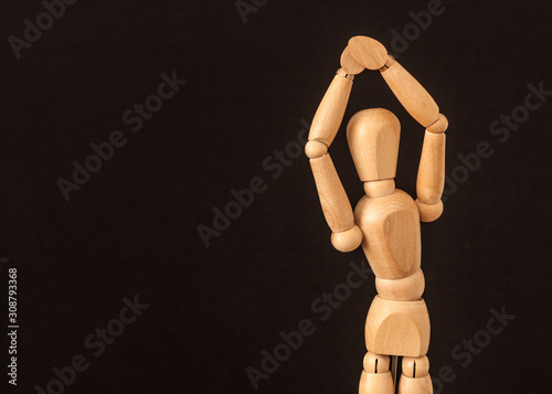 wooden mannequin with hands up