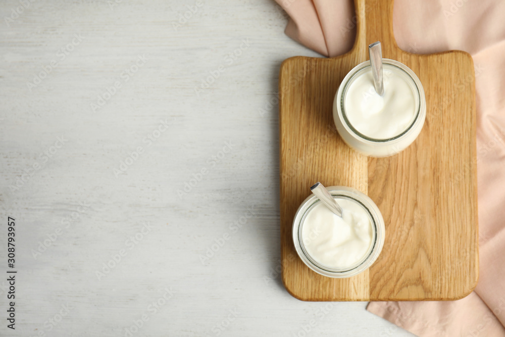 Tasty organic yogurt on white wooden table, flat lay. Space for text Tasty organic yogurt on white wooden table, flat lay. Space for text