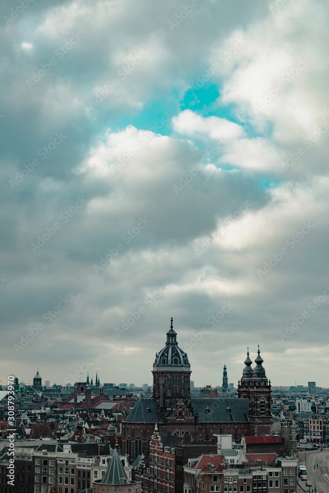 Old centre of the city of Amsterdam under cloudy sky in autumn. High angle view.