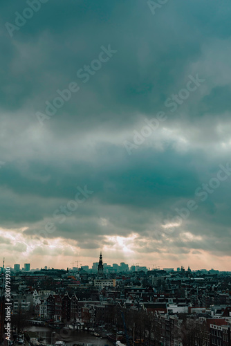 Old centre of the city of Amsterdam under cloudy sky in autumn. High angle view.