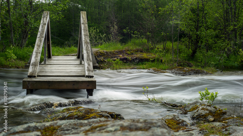 river flows under a small bridge
