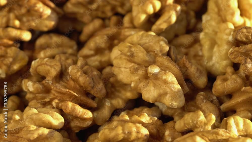 Walnut close up. product rich in minerals and vitamins. Walnut turns in a shot. Walnut kernels rotating. walnut close up lies under beams of the sun. Macro Walnut close up. product rich in minerals and vitamins. Walnut turns in a shot. Walnut kernels rotating. walnut close up lies under beams of the sun. Macro