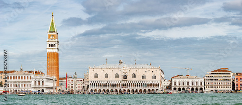 Panoramic view of Doge Palace, Campanile and San Marco square from busy Grand Canal water during evening, Venice, Italy, summer time