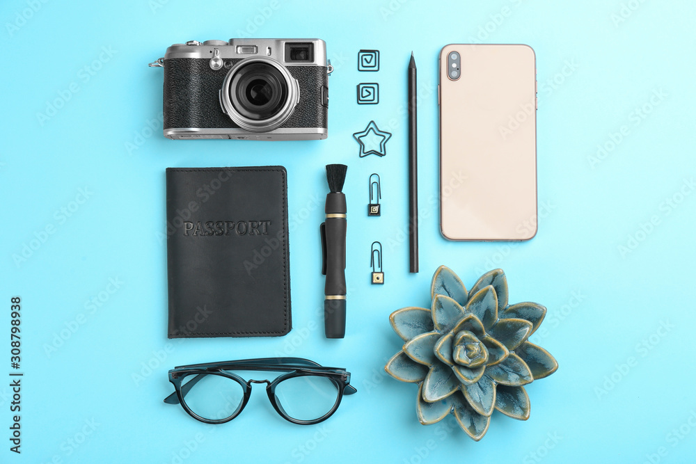 Flat lay composition with camera for professional photographer and smartphone on light blue background - obrazy, fototapety, plakaty 