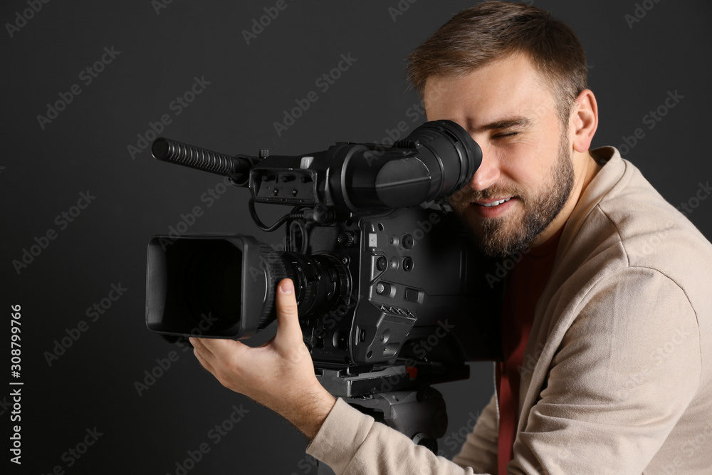 Operator with professional video camera on black background Operator with professional video camera on black background